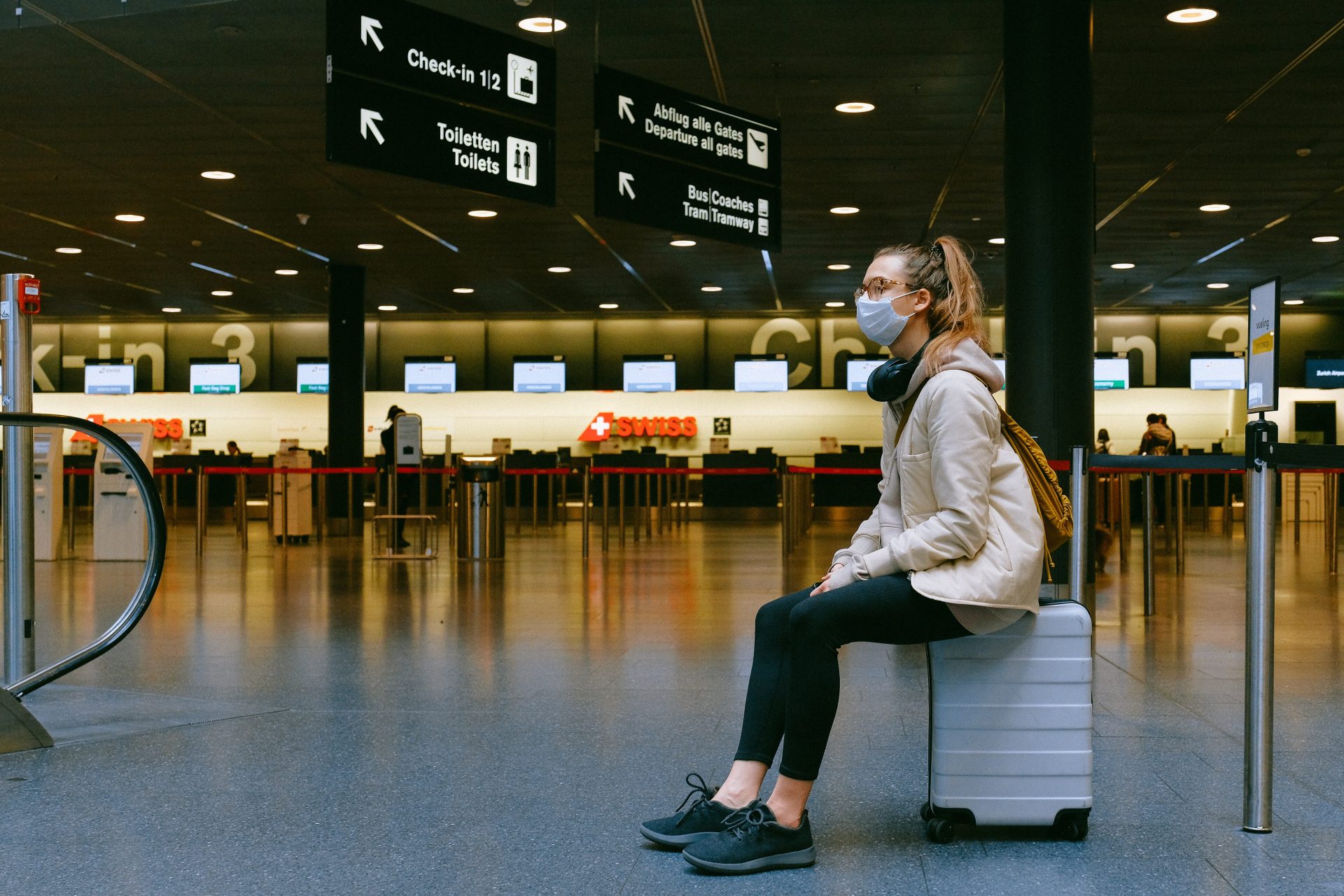 woman-sitting-on-luggage