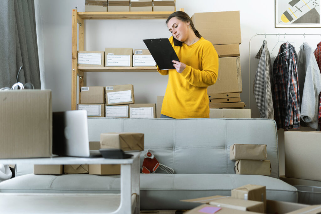 SME delivery e-commerce telemarketing seller concept. startup small business entrepreneur SME freelance woman working with box, online seller confirming orders from customer on the phone. Copy space