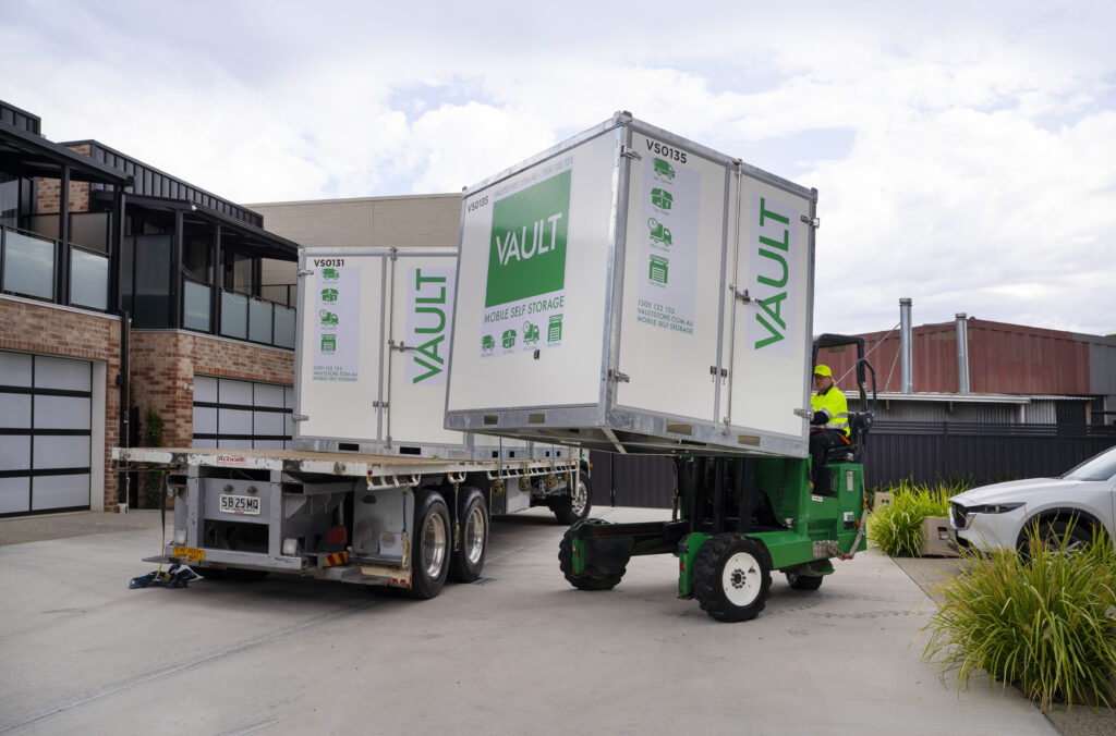 Vault Mobile Storage trucks parked outside a home