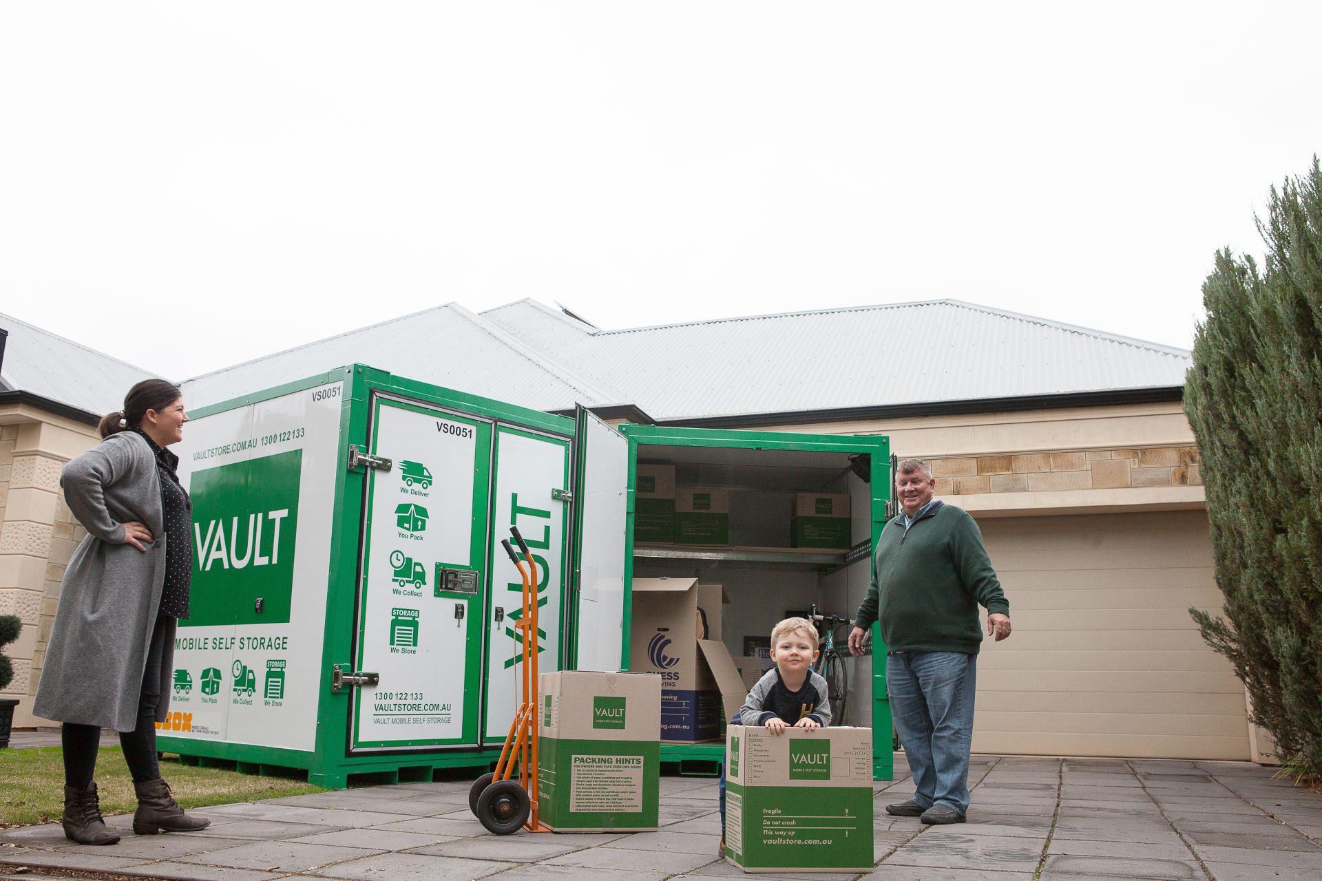A man and woman pose in front of a moving container, highlighting the benefits of mobile storage solutions.